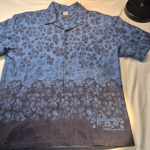 L2 Modern Paradise Short Sleeve Blue Button Down Shirt with Tropical Leaf Design
